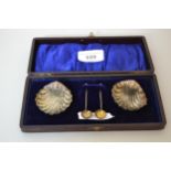 Cased pair of silver shell form salts with spoons