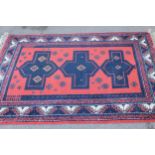 Turkish rug with triple medallion and multiple borders on a red ground, approximately 68ins x 45ins