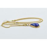 Middle Eastern yellow metal and lapis teardrop pendant on a yellow metal curb link chain, the