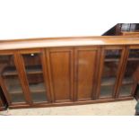 Large late 19th Century mahogany low bookcase, having moulded top above two central panelled
