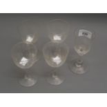 Set of four Edwardian engraved drinking glasses, together with floral and bird drinking glass