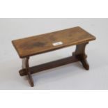 Unusual miniature yew wood model of a trestle ended table with stretcher, 6.5ins high x 13ins long x