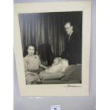 Large format portrait photograph of the young Princess Elizabeth and Prince Philip with baby