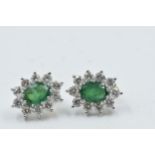 Pair of yellow and white gold oval emerald and diamond cluster earrings, the emeralds