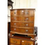 Small reproduction mahogany bow front chest of two short and three long drawers with ring handles