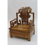 Mid 20th Century Chinese low seat armchair having floral carved and pierced panelled back and scroll