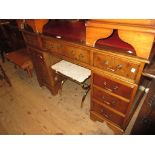 Reproduction yew wood twin pedestal desk with a red leather inset top above nine drawers with