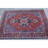 Small Qashqai rug with a lobed medallion and all-over stylised design on a red and blue ground