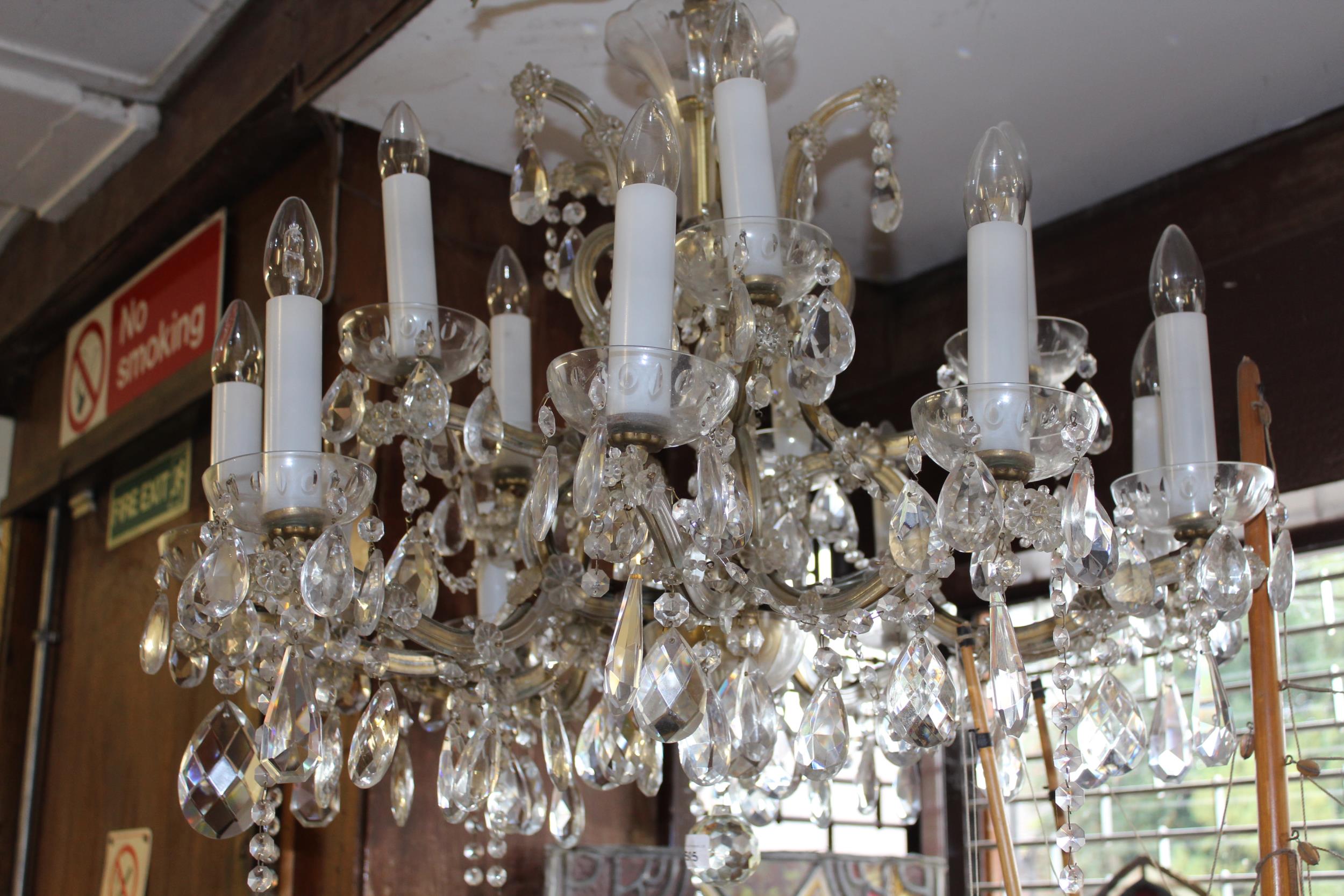 Mid 20th Century glass and gilt brass fifteen light electrolier, the shaped arms with multiple