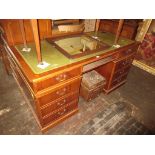 Reproduction yew wood green leather inset desk, having two drawers with central sliding tray and two