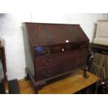 1920's Mahogany bureau with a fall front above three drawers, raised on carved cabriole claw and