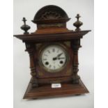 Late 19th Century walnut mantel clock by Junghans, the ceramic dial with Roman numerals and a two
