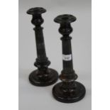 Pair of serpentine circular turned and polished candlesticks, with faceted stems (some chips), 12ins