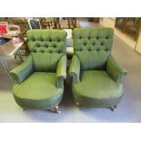 A pair of Victorian style green button upholstered library arm chairs on turned supports with