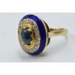 18ct Yellow gold dress ring set central cabochon sapphire surrounded by band of diamonds and blue