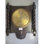 Early 20th Century oak aneroid barometer with brass dial, 17ins high
