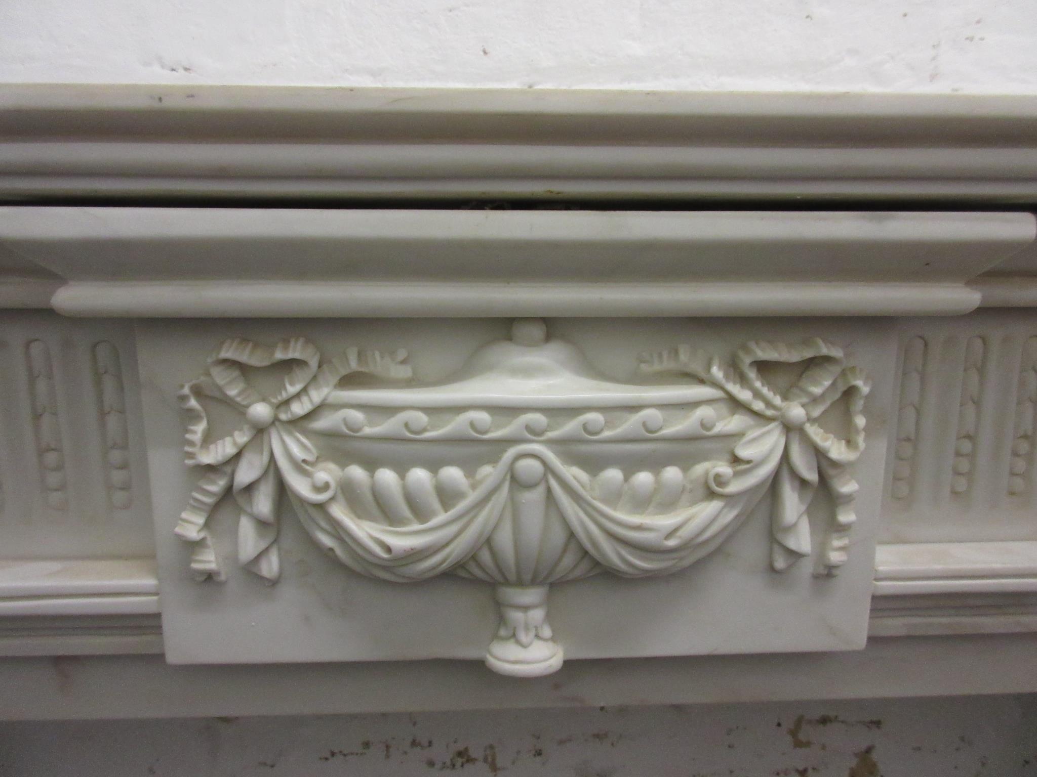 Large white marble fire surround having a moulded mantelpiece, above a central urn with bows and - Image 2 of 12