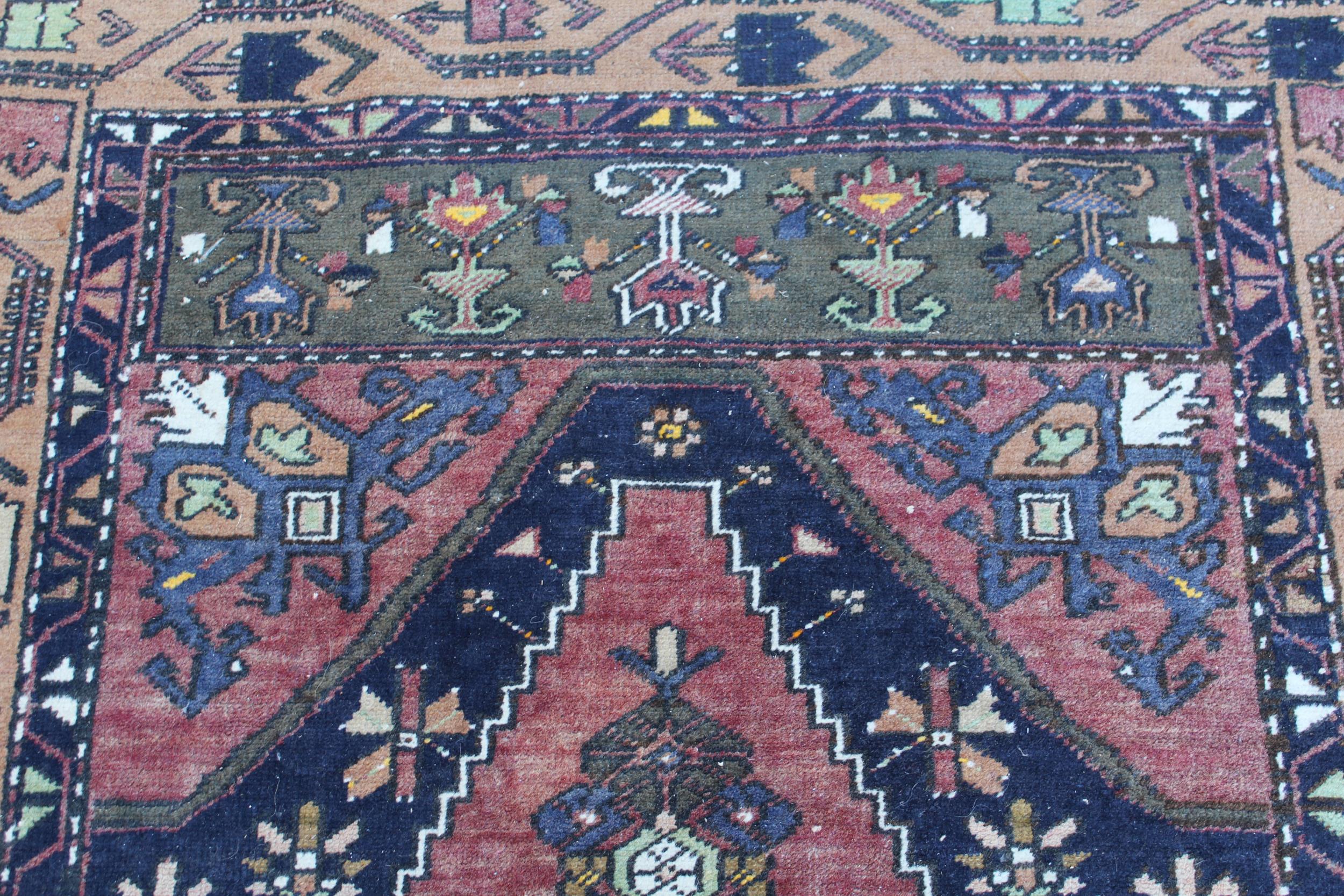 Kurdish rug with centre medallion and all-over floral design on a dark red ground with borders, - Image 2 of 3