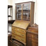 Edwardian mahogany and satinwood crossbanded bureau with an associated bookcase top, together with a