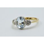 18ct Yellow gold ring set oval aquamarine flanked by two brilliant cut diamonds Ring size M/N
