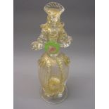Murano glass figure holding a flower in clear gold flecked glass, 12ins high