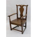 George III oak open elbow chair, the shaped splat back above panel seat, on square moulded