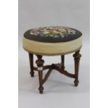 19th Century circular woolwork upholstered footstool, raised on turned and fluted beechwood supports