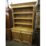 20th Century pine dresser having moulded cornice above three fixed shelves, with carved applied half