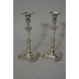Pair of matched silver tapered and fluted stem candlesticks, on octagonal plinth bases, 11ins