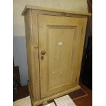 Stripped pine side cabinet with a single panel door, 26ins wide x 16ins deep x 41ins high