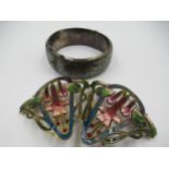 Gilt metal and enamel decorated buckle of floral design, together with a silver bangle