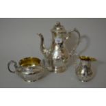 Victorian silver three piece coffee service with engraved floral decoration, the coffee pot with