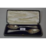 Cased pair of silver berry spoons with embossed decoration, hallmarked London 1780, maker Thomas
