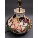 Modern Moorcroft table lamp decorated with Autumn berries and foliage on a cream ground, 7.5ins high