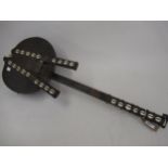 Native six stringed musical instrument, all-over leather covered and mounted with Cowrie shells
