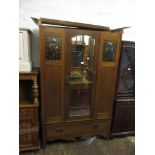 Small Arts and Crafts oak wardrobe with single mirrored door and inset copper panels, and a matching