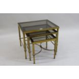 Nest of three mid 20th Century brass and glass inset rectangular occasional tables, 22ins wide