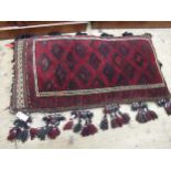 Afghan carpet fragment covered floor cushion with bead and shell work tassels, 24ins x 44ins