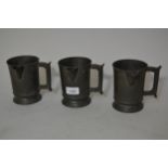 Three 19th Century pewter one pint jug measures, inscribed to the bases ' Royal Oak, Dorking '