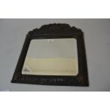 Small 19th Century bronzed cushion frame wall mirror, the shaped pediment with a central classical