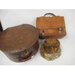 Brown fibre hat box containing a pheasant feather hat, together with a leather briefcase
