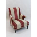 Attributed to Andrew Martin, modern armchair with striped Kelim upholstery, raised on ebonised