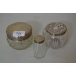 Three various silver mounted glass dressing table jars (at fault)