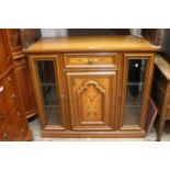 Reproduction marquetry inlaid side cabinet with a central drawer above a panelled door, flanked by