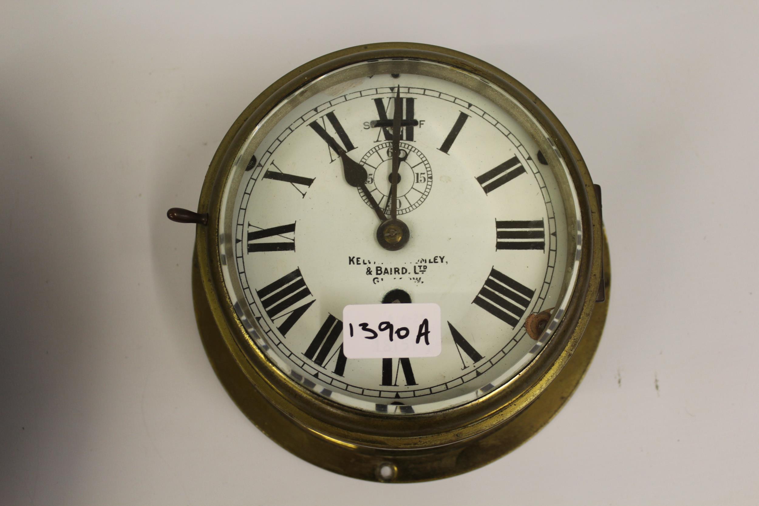 Kelvin Bottomley & Baird, ships circular brass bulk head clock with enamel dial, Roman numerals