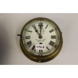 Kelvin Bottomley & Baird, ships circular brass bulk head clock with enamel dial, Roman numerals