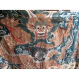 Late 19th / early 20th Century Chinese silk and gold threadwork wall hanging depicting a dragon on a