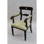 William IV mahogany open armchair, the carved and moulded rail back above moulded and padded arms,