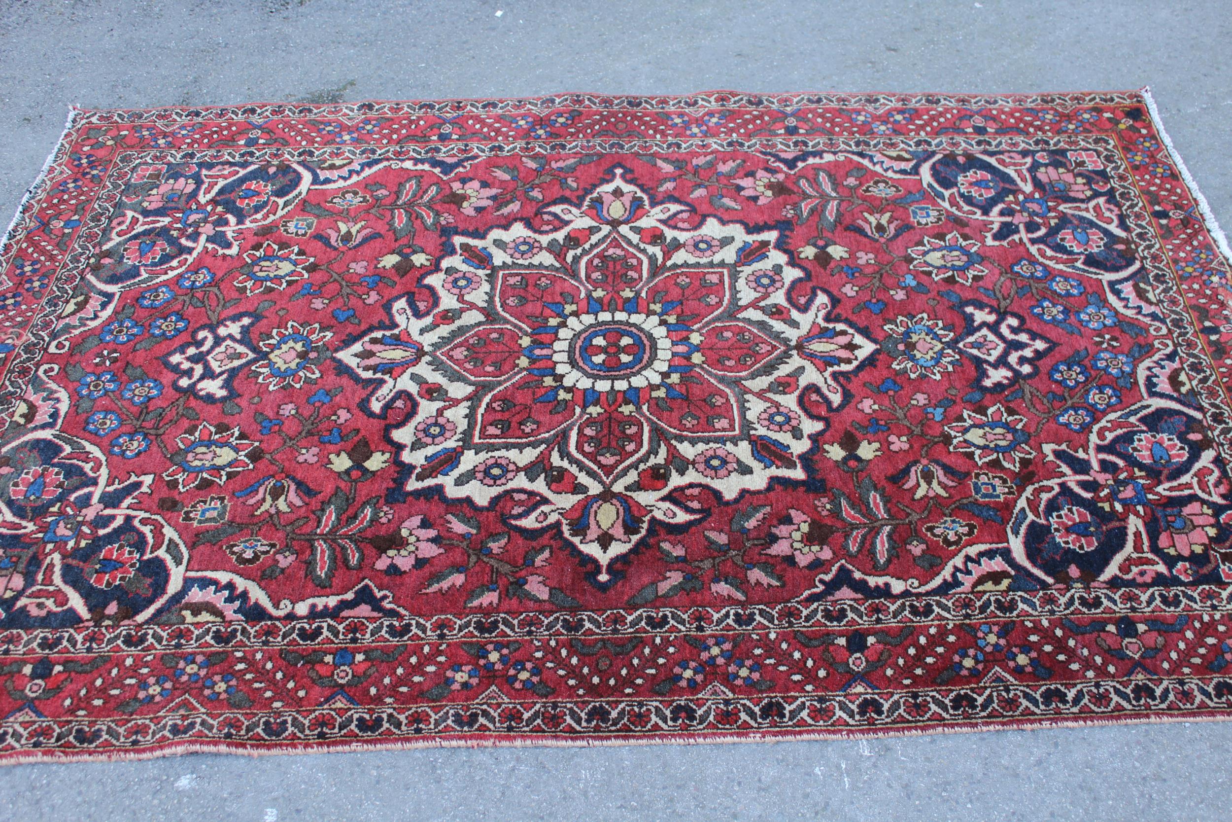 Bakhtiari rug with centre medallion and all-over floral design with border (worn), approximately