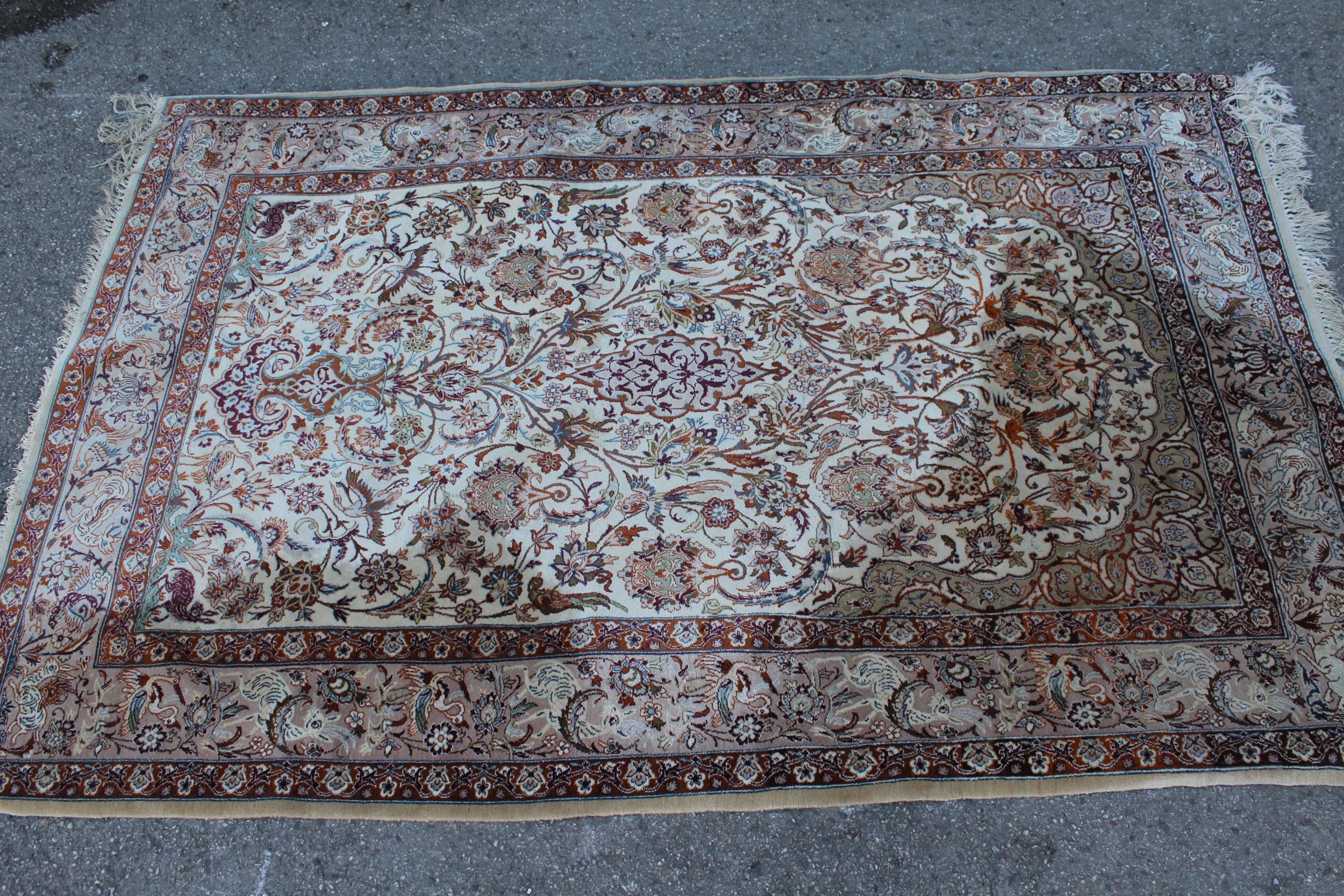 Indo Persian rug of all-over floral and bird design with multiple borders on a beige ground,